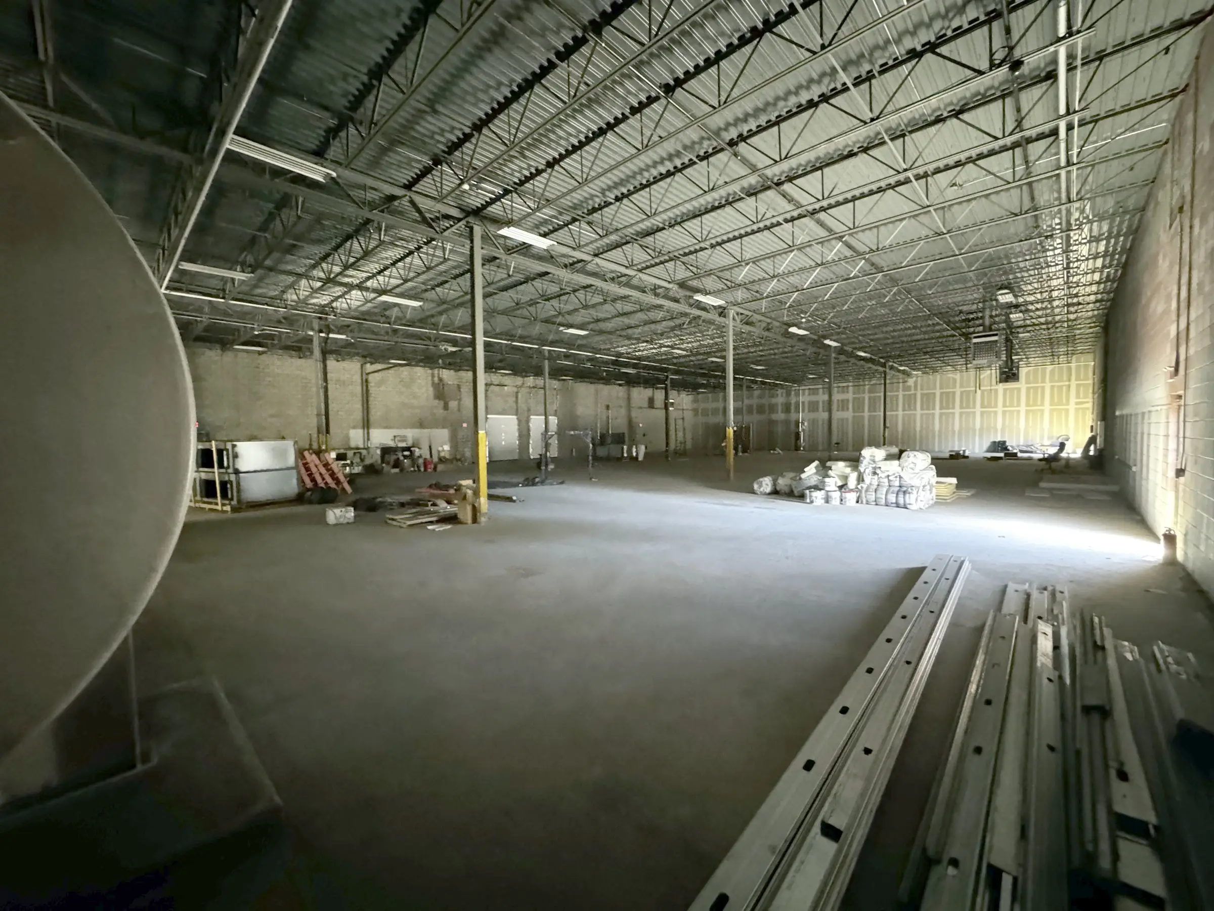 Warehouse interior with daylight from an open door along the side wall