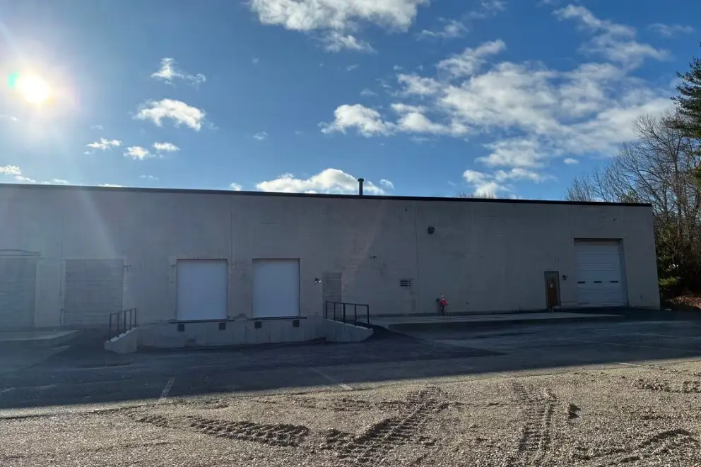 Rear of the building with loading doors and the open truck lot